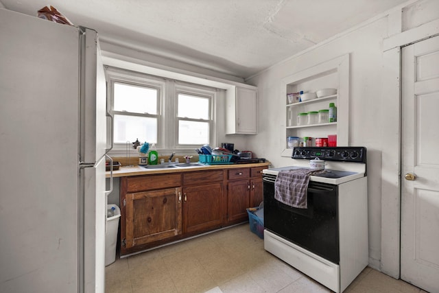 106 18th St, Corbin, KY 40701 - kitchen with light tile patterned floors, white appliances, sink, and a textured ceiling