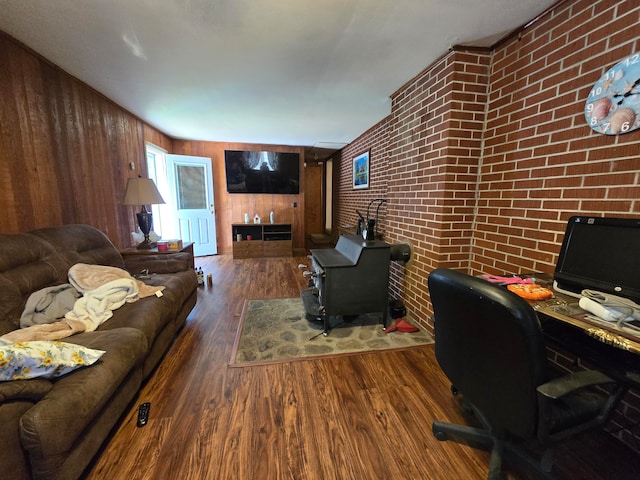 interior space featuring brick wall, dark hardwood / wood-style flooring, and wooden walls