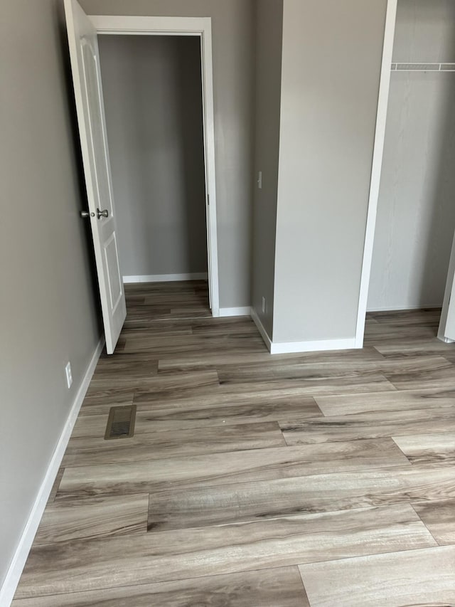 unfurnished room with light hardwood / wood-style floors