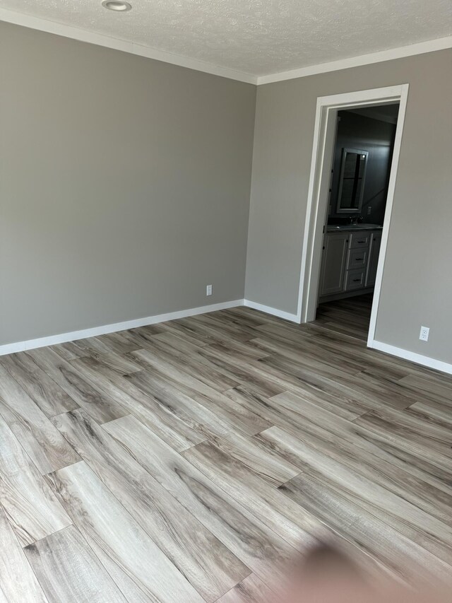 unfurnished room featuring hardwood / wood-style floors and a textured ceiling