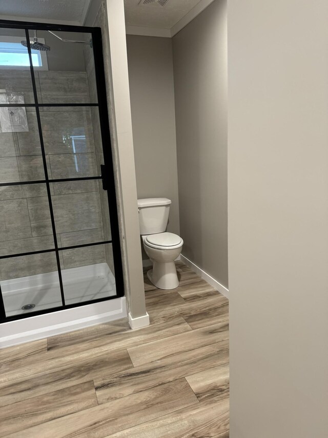 bathroom featuring hardwood / wood-style flooring, dual vanity, and toilet