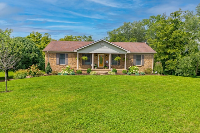 ranch-style house featuring brick siding and a front yard