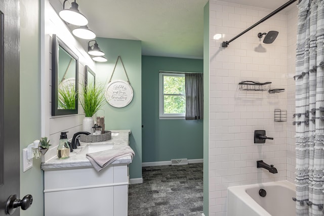 bathroom with shower / bath combination with curtain, vanity, visible vents, and baseboards