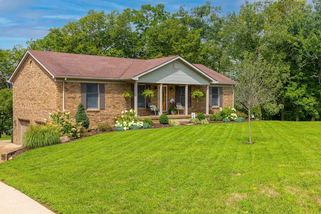 ranch-style house with covered porch, brick siding, an attached garage, and a front lawn