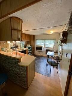 kitchen with kitchen peninsula and hardwood / wood-style floors