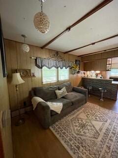 living room with wood walls and wood-type flooring