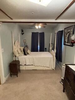 bedroom with light colored carpet and ceiling fan