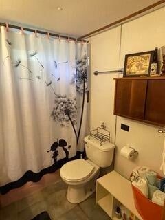 bathroom with tile patterned flooring and toilet