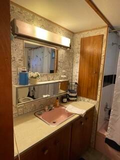 bathroom with vanity and shower / bath combo with shower curtain