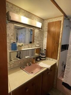 full bathroom with shower / bath combo and vanity