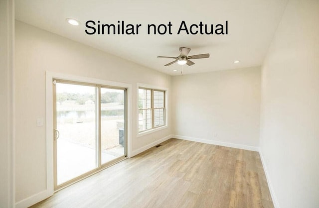 spare room featuring ceiling fan and light hardwood / wood-style flooring