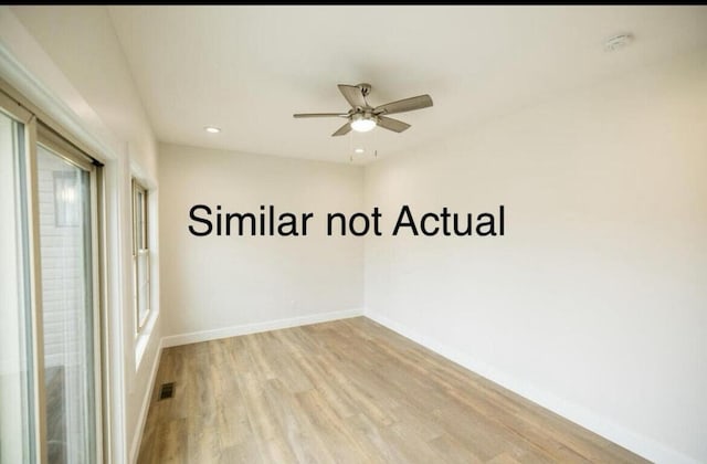 empty room featuring light wood-type flooring and ceiling fan