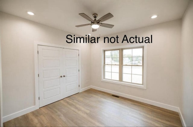 interior space featuring a closet, light hardwood / wood-style floors, and ceiling fan