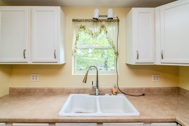 kitchen with sink and white cabinets