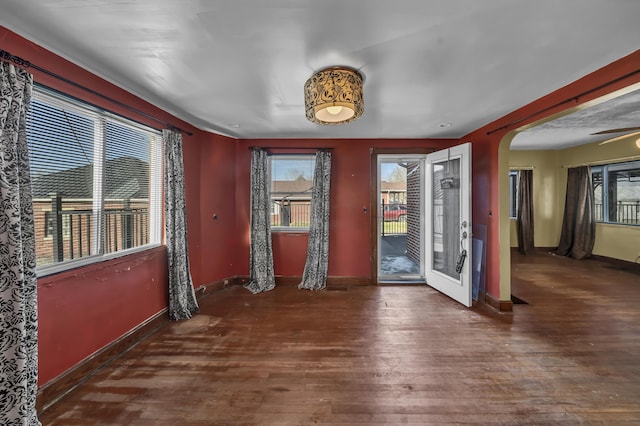 interior space with a healthy amount of sunlight and dark hardwood / wood-style flooring