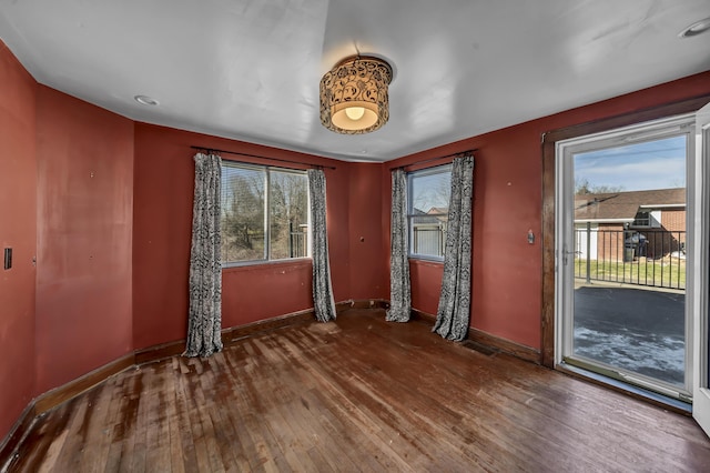 unfurnished room with hardwood / wood-style flooring