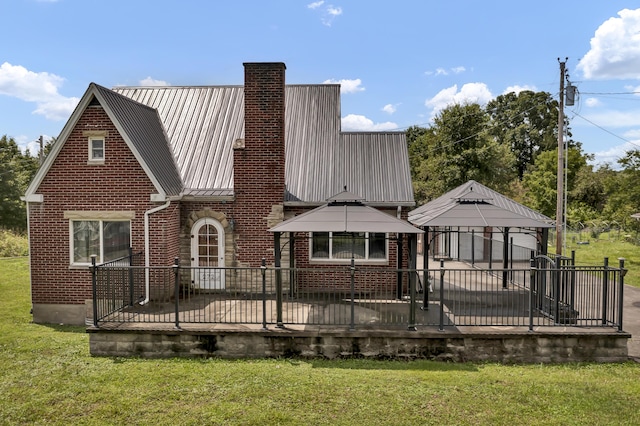 back of house with a gazebo and a lawn