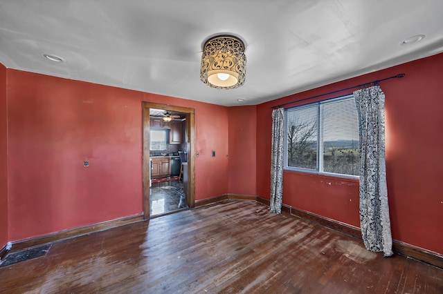 empty room with dark hardwood / wood-style flooring