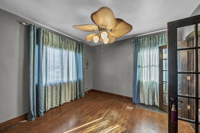 unfurnished room featuring wood-type flooring, ceiling fan, and french doors