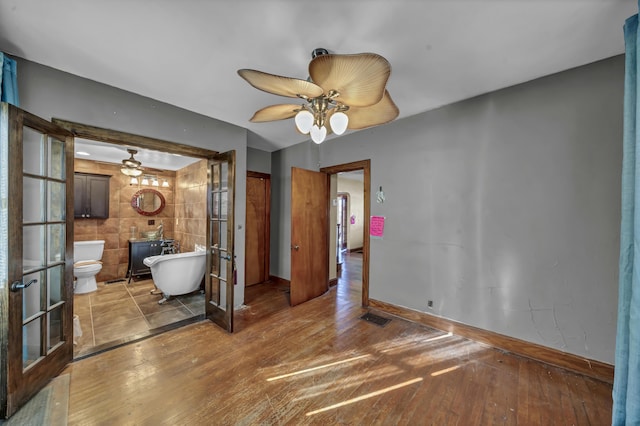 interior space featuring french doors, ceiling fan, and hardwood / wood-style flooring