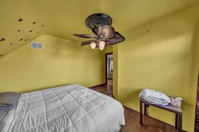 bedroom with dark hardwood / wood-style flooring and vaulted ceiling