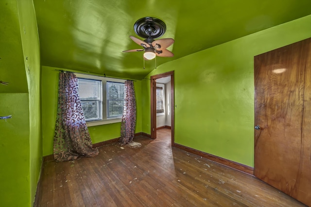 spare room with ceiling fan, lofted ceiling, and dark hardwood / wood-style floors