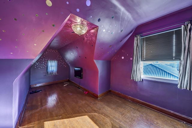 additional living space featuring hardwood / wood-style flooring and lofted ceiling