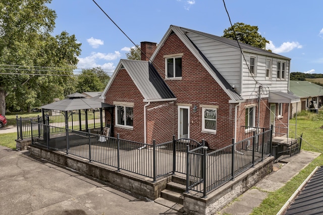 rear view of house featuring a gazebo