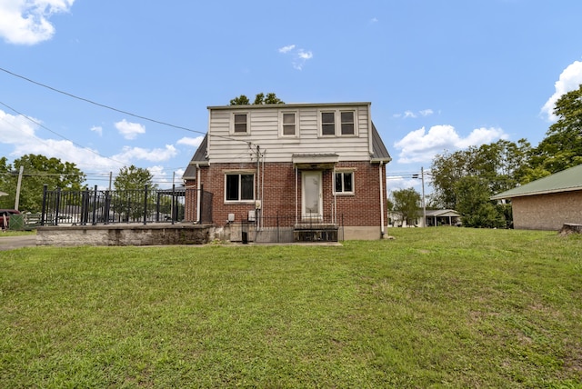 rear view of property with a lawn