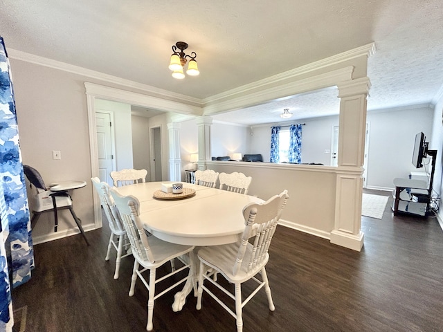 dining space featuring crown molding, dark wood-type flooring, a textured ceiling, and ornate columns