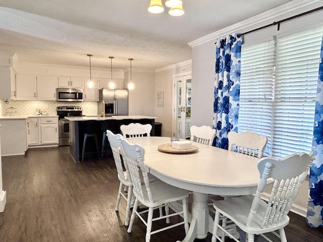 dining area with crown molding and dark hardwood / wood-style flooring