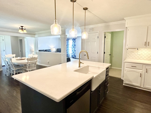 kitchen with sink, hanging light fixtures, dishwasher, an island with sink, and white cabinets