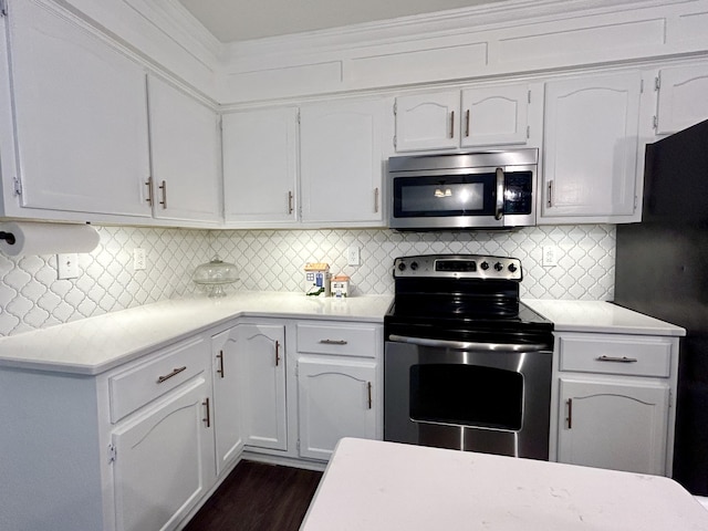 kitchen with white cabinetry, stainless steel appliances, dark wood-type flooring, and decorative backsplash