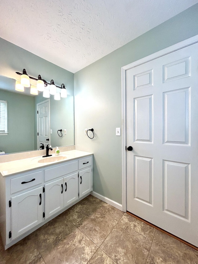 bathroom with vanity and a textured ceiling