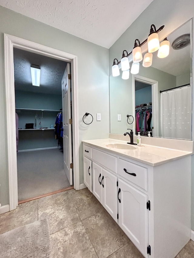 bathroom featuring vanity and a textured ceiling