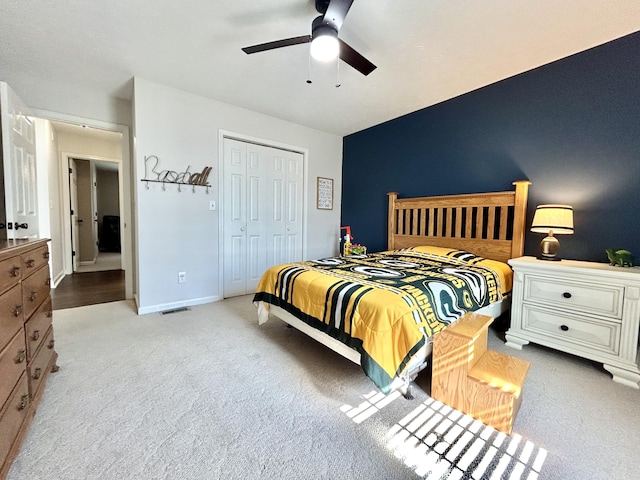 carpeted bedroom with vaulted ceiling, a closet, and ceiling fan