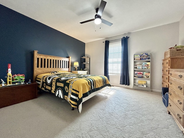 bedroom featuring ceiling fan and carpet