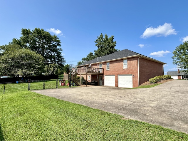 view of home's exterior with a wooden deck, a garage, and a lawn