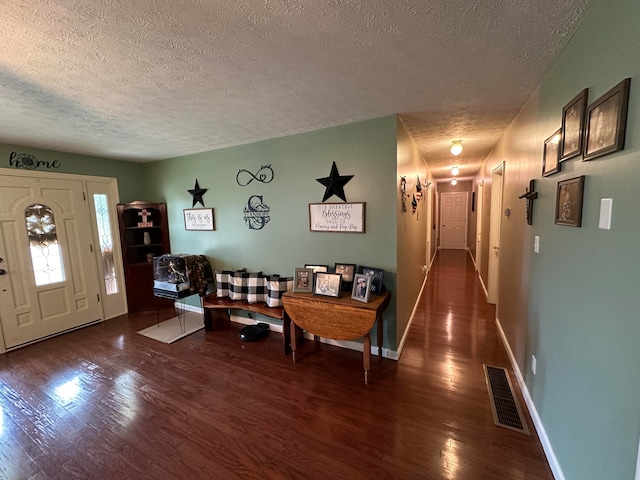 interior space featuring dark hardwood / wood-style flooring and a textured ceiling