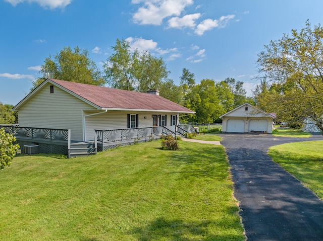 view of front of home featuring a garage, a front lawn, a wooden deck, and an outdoor structure