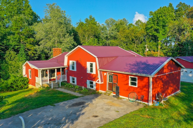 tri-level home with covered porch and a front lawn