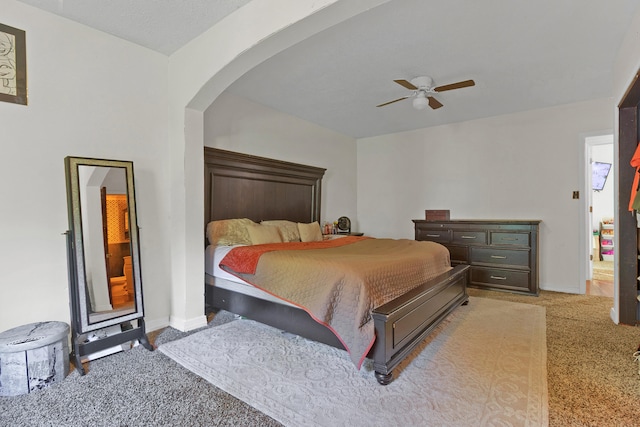 bedroom featuring ceiling fan, light carpet, and a textured ceiling