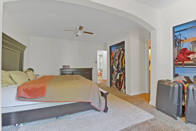 carpeted bedroom featuring ceiling fan and a closet