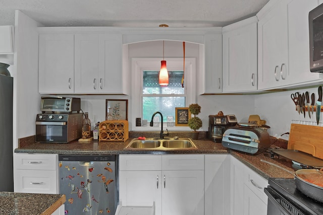 kitchen with decorative light fixtures, sink, white cabinetry, and dishwasher