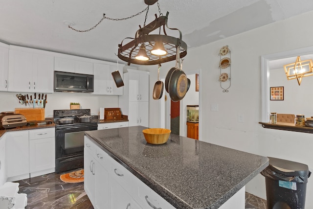 kitchen featuring pendant lighting, white cabinets, a center island, dark stone countertops, and black range with electric cooktop