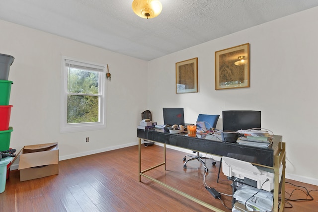 office space featuring wood-type flooring and a textured ceiling