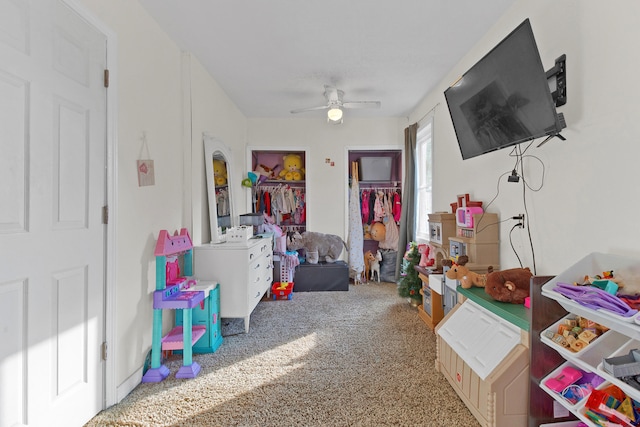 recreation room with ceiling fan and carpet floors