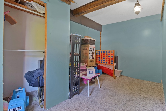 rec room with carpet floors and beam ceiling