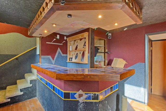 interior space featuring tile counters and hardwood / wood-style flooring