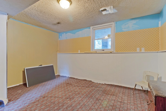 spare room with a textured ceiling